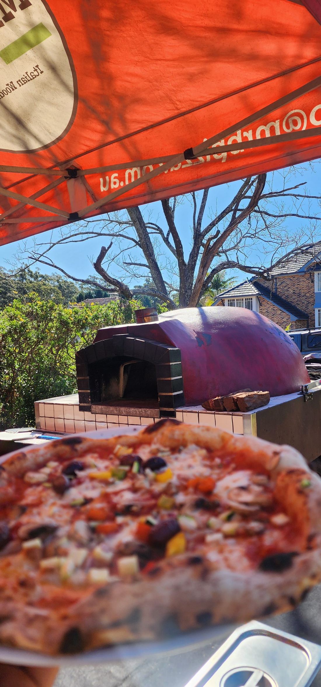 Azzurri authentic mobile wood-fired pizza oven on-site at a Sydney event — real Italian wood-fired pizza catering setup
